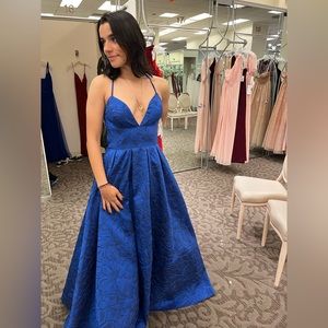 It’s a beautiful blue vibrant ball gown dress. I wore it to prom last year.